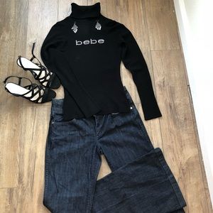 Bebe woman’s Black turtle neck sweater size medium